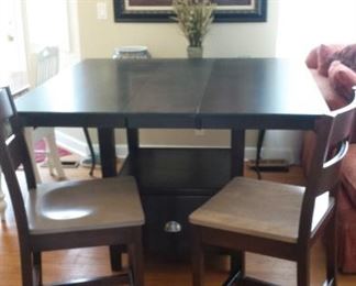 PUB TABLE BY GASCHO! COMES WITH TWO (2) LEAVES AND EIGHT (8) PUB CHAIRS!