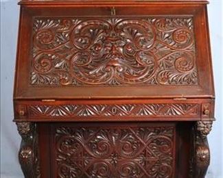 083a Mahogany heavily carved desk with standing winged griffin column front, top gallery with bevel mirrors and end drawers, attrib. to R.J. Horner, 60 in. T, 38 in. W, 24 in. D.