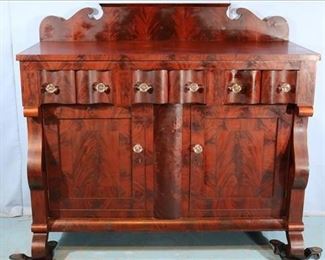 107a Mahogany Empire sideboard with back splash, serpentine drawers, original glass pulls and scroll front and feet, 57 in. T, 61 in . W, 25 in D.