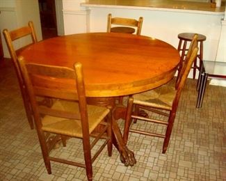 Antique claw foot table and four ladderback chairs.
