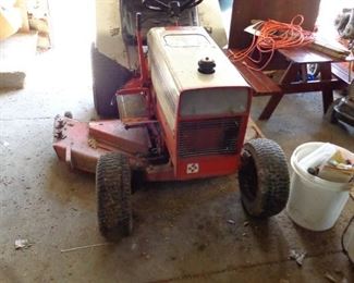 Gravely lawn tractor with several attachments.