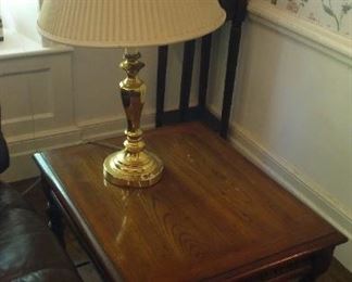 One of 2 tables with one of 2 brass lamps.