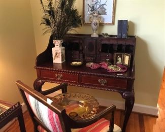 Nice writing desk, peacock feathers, and desk chair.