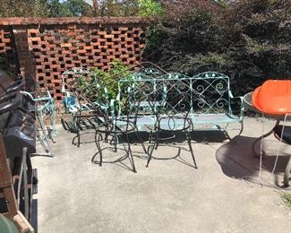 Many pieces of metal patio furniture.