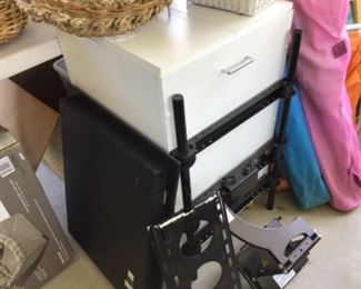 TV wall mount and small white store chest on wheels