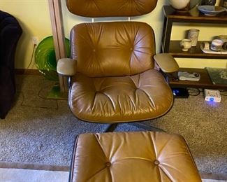 One of the pair of Eames chairs available with ottoman