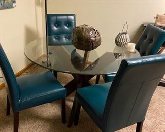 Cool glass topped table with aqua leather look chairs