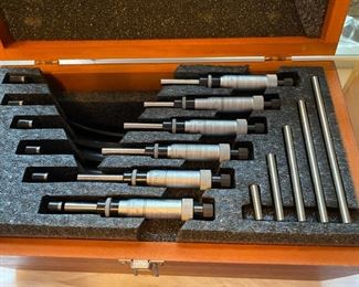 Starrett micrometer set in wooden case.