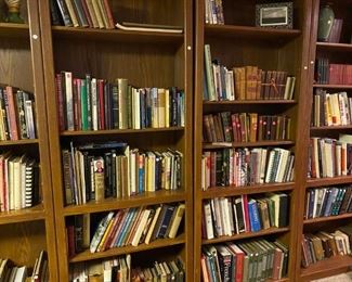 Several of our many bookshelves filled with books.
