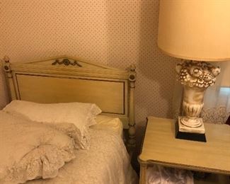 One of the two twin beds and the nightstand