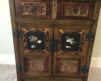 Beautiful Chinese Chest from China.  Carved front with different colors of Jade. Beautiful paintings on top and sides.  Purchased during one of their many trips.