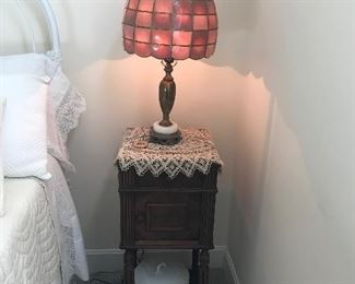 This picture has several beauties.  The Lamp is a shell lamp with a marble base.  It is sitting on one of Sues favorite style of doilies covering a wonderful commode with a granite top.  The Chamber Pot with lid is in great condition.