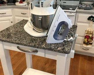 Wonderful little kitchen Island with Granit top on wheels.  Kitchen Aid Mixer and Rowenta Iron for those of you who still Iron!