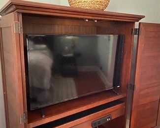Inside of entertainment cabinet and Vizio flat screen TV 