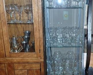 4 SIDED GLASS DISPLAY CASE MULTI SHELVES  AND A VERY LARGE SELECTION OF STEMWARE