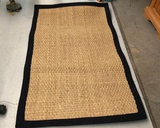 We have two of these super nice jute rugs with black trim. 