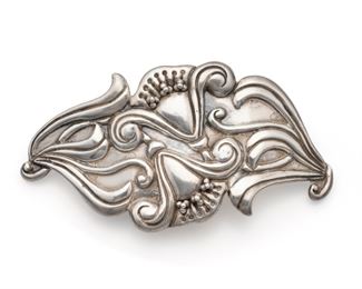 1011
A Valentin Vidaurreta Sterling Silver Belt Buckle
Pre-1948; Taxco, Mexico
Stamped: Sterling
Designed with repousse flowers with applied spherical stamens
2.625" H x 4.875" W
56.0 grams
Estimate: $600 - $800