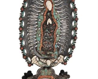 1022
A Matl Virgen De Guadelupe Silver Santos Figure
1934-1948; Taxco, Mexico
Stamped: Matl
Designed by Matilde Poulat, adorned with abalone, turquoise, coral, simulated diamonds and a simulated ruby
7.625" H x 4" W x 1.5" D
230.5 grams
Estimate: $1,500 - $2,000
