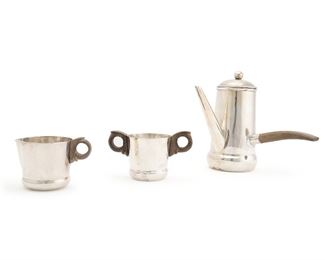 1032
A William Spratling Sterling Silver Chocolate Set
1933-1946; First Design Period
Two stamped for William Spratling and Sterling including: Taxco Mexico / 925; One stamped: Spratling Silver
The assembled set comprising a chocolate pot, a cream jug and a sugar bowl with sterling and wood handles, 3 pieces
Chocolate: 6" H x 5.25" W x 7" D
17.035 oz. troy approximately
Estimate: $600 - $800