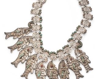 1042
A Matl Sterling Silver Fish Necklace
1934-1948; Taxco, Mexico
Stamped: Matl / Sterling / 925
Designed by Matilde Poulat, the turquoise-set swirl necklace designed with repousse fish fringe
17" L x 3" H
144.0 grams
Estimate: $2,000 - $3,000
