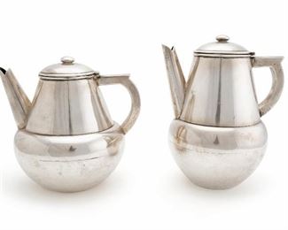 1054
A Conquistador Mexican Sterling Silver Tea And Coffee Pot
Mid-20th Century; Mexico City; Mexico
Each stamped: Conquistador / Sterling Mexico / 925/1000 / [Eagle 13]
Comprising a sterling silver coffee pot and tea pot with streamlined handles and bulbous tapered bases, 2 pieces
Coffee: 8" H x 6.5" W x 5.25" D; Tea: 7" H x 7.125" W x 5.75" D
47.390 oz. troy approximately
Estimate: $500 - $700
