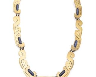 1058
An Erika Hult De Corral Brass And Sodalite Necklace
Third-quarter 20th Century
Stamped: Ric / Hecho en Mexico / Laton / 035
The Mixtec-inspired links suspending a stepped pendant and further set with sodalite cabochons
25.5" L x 2.325" H x 2.325" W
Estimate: $200 - $300