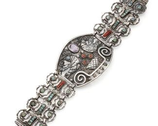 1089
A Matl Silver And Gem-Set Dove Bracelet
1934-1948; Taxco, Mexico
Signed: Matl
Designed by Matilde Poulat, the central panel with two dovers and a basket flanked by scrolled links set with coral and turquoise
7" L x 1.75" H
52.5 grams
Estimate: $800 - $1,200