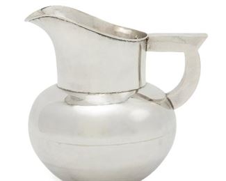 1092
A Hector Aguilar Sterling Silver Water Pitcher
1940-1945; Taxco, Mexico
Stamped for Hector Aguilar; Further stamped: Made in Mexico / Sterling / [Indistinct Eagle]
The smooth-finished pitcher with bulbous body and streamlined geometric handle
7.5" H x 7.75" W x 6.5" D
32.785 oz. troy approximately
Estimate: $600 - $800