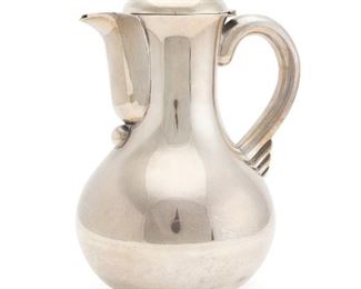 1097
A Hector Aguilar Sterling Silver Lidded Pitcher
Third-quarter 20th Century
Stamped: Eagle 9 / Sterling / 3522
The ball finial over a hinged lid covering a smooth-finish body issuing a handle terminating in a stylized wing design
9.75" H x 7" W x 5.5" D
39.615 oz. troy approximately
Estimate: $500 - $700