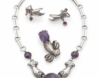 1143
A Suite Of William Spratling Silver And Amethyst Jewelry
1940-1944; First Design Period; Taxco, Mexico
All stamped for William Spratling; Further stamped: Made in Mexico / Silver
Each designed with hands with amethyst motif, comprising a necklace (16.5" L x 1.125" H), a brooch (2" H x 1.125" W), and a pair of screw-back ear clips with amethyst drops (1" H x 1.125" W), 4 pieces
96.0 grams
Estimate: $1,200 - $1,800