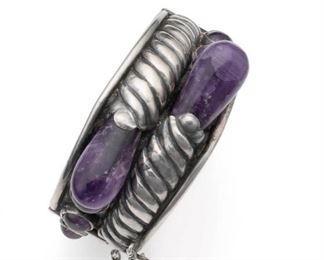 1144
A William Spratling Silver And Amethyst Hinged Bangle Bracelet
1940-1944; First Design Period; Taxco, Mexico
Stamped for William Spratling; Further stamped: Made in Mexico / Silver
Designed as a hinged bangle of crossover design terminating with two amethyst teardrops
6.75" C x 1.25" H, wrist opening: 1.5"
73.0 grams
Estimate: $1,500 - $2,000