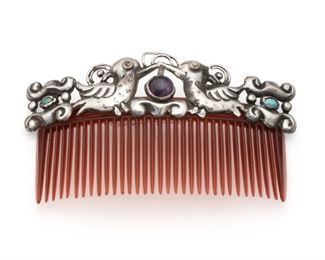 1157
A Matl Hair Comb
1934-1940
Stamped: Matl
Designed by Matilde Poulat, centering two kissing doves with a hollow silver frame attached to a faux tortoise-shell comb
Overall: 2.5" H x 4.325" W; Silver: 1.5" H
28.0 grams gross
Estimate: $500 - $700