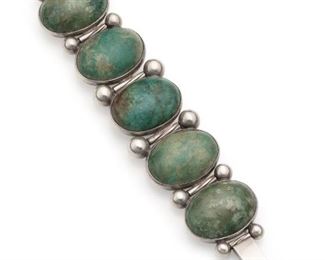 1172
A Hector Aguilar Sterling Silver And Green Hardstone Bracelet
1948-1955; Taxco, Mexico
Stamped for Hector Aguilar; Eagle 3; Further stamped: 940 / Taxco
Designed with oval green hardstone alternating with silver rod and ball segments
6.5" L x 1.5" H
102.0 grams
Estimate: $600 - $800