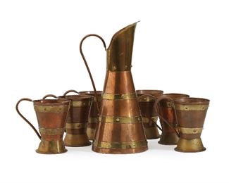 1175
A Hector Aguilar Copper And Brass Drink Set
Third-quarter 20th Century; Taxco, Mexico
Stamped for Hector Aguilar; Further stamped: Taxco / 994
Comprising a pitcher and six handled cups, 7 pieces
Pitcher: 13" H x 6.325" W x 5.75" D; Cups: 5.125" H x 5.625" W x 3.75" D
Estimate: $200 - $400