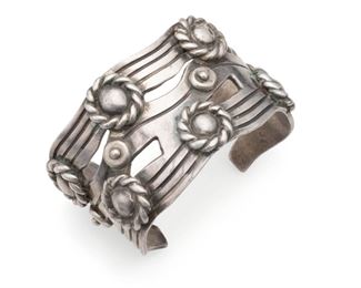 1185
A William Spratling "River Of Life" Silver Cuff Bracelet
1940-1944; First Design Period
Stamped for William Spratling; Further stamped: Made in Mexico / Spratling Silver
Designed as silver waves with roped Aztec rings
7.5" C x 1.875" H; Wrist opening: 1.5"
170.5 grams
Estimate: $800 - $1,200
