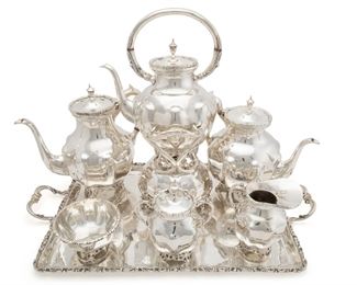 1198
A Mexican Sterling Silver Tea And Coffee Set
Third-quarter 20th Century; Mexico City, Mexico
Each piece stamped for sterling [Eagle 1]; Futher stamped: Sterling 0924 / Hecho en Mexico / MERJ
Comprising a personalized tray (1.5" H x 22" W x 12.5" D), a tipping kettle (15" H x 9" W x 7.25" D), a coffee pot (9.625" H x 10.25" W x 6.25" D), a tea pot (9" H x 10.25" W x 6.5" D), a sugar pot (6" H x 5.25" W x 3.75" D), a cream jug (5.25" H x 4.75" W x 3.25" D), and a small dish (2.5" H x 4.5" Dia.), 7 pieces
245.745 gross oz. troy approximately
Estimate: $3,000 - $5,000