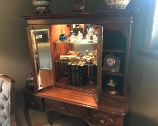 Desk style cabinet with lighted middle section and open shelves on each side