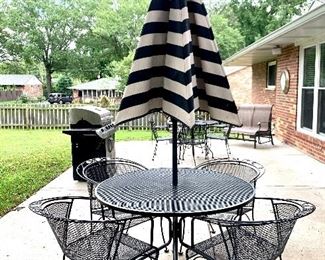 $250 - Black Patio Set with 4 Chairs and Striped Umbrella. This set features a floral design on each chair. Table measures 47" diameter x 28" tall and chairs measure 20" x 17" x 28".