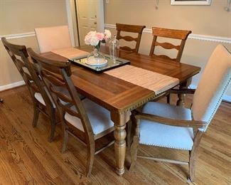 Dining room table with 6 chairs.  There is one leaf to make the table bigger.