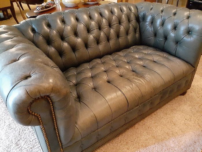 Tufted green leather loveseat