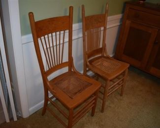 A pair of Antique Press Back Chairs featuring Spindle Backs and Cane Seating both chairs have been in the family since the 1800's