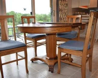 Antique Round Oak Table and 4 Chairs complete with leaf. It is late 1800's and in Wonderful condition.