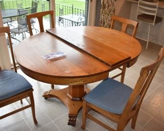 Antique Round Oak Table and 4 Chairs complete with leaf. It is late 1800's and in Wonderful condition. Just look at the Beautiful Finish on the Table Top!