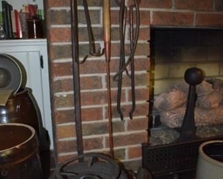 Primitive Iron Dutch Oven with Stand plus Tongs hanging on Fireplace and More. The Andirons are not for sale as they are going with Mrs Roark.