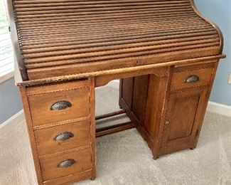 $295 Vintage four drawer and one cabinet roll top desk and chair.  45"H x 31"D x 48"W