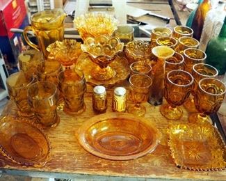 Amber Glass Assortment Including Ruffled Edge Pedestal Bowls, Drinking Glasses, Serving Trays, Salt And Pepper Shakers, And More