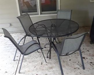 Round wrought iron table and four chairs