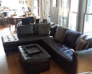 Black tufted sectional and ottoman