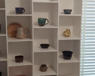 lots of pieces of pottery--shelves are built in home --not for sale--sorry
