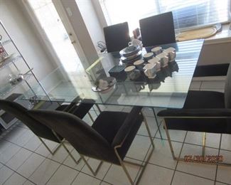 Beautiful Glass top table on metal base. 78 x 42". Chairs need work. 2 chairs arms are off, but included with the chairs. One corner of table is chipped. See following pics